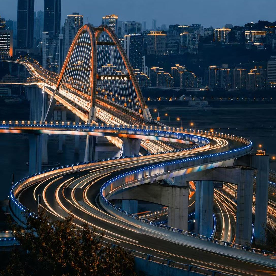 Chongqing's illuminated road network and bridge at blue hour