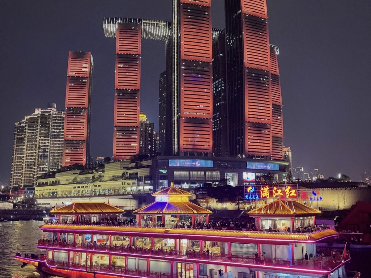 Two Rivers cruise boat with Chongqing's illuminated skyline and river reflections