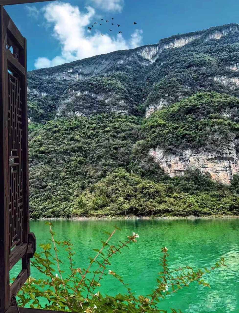 The Wu River valley framed by traditional buildings in Gongtan Ancient Town