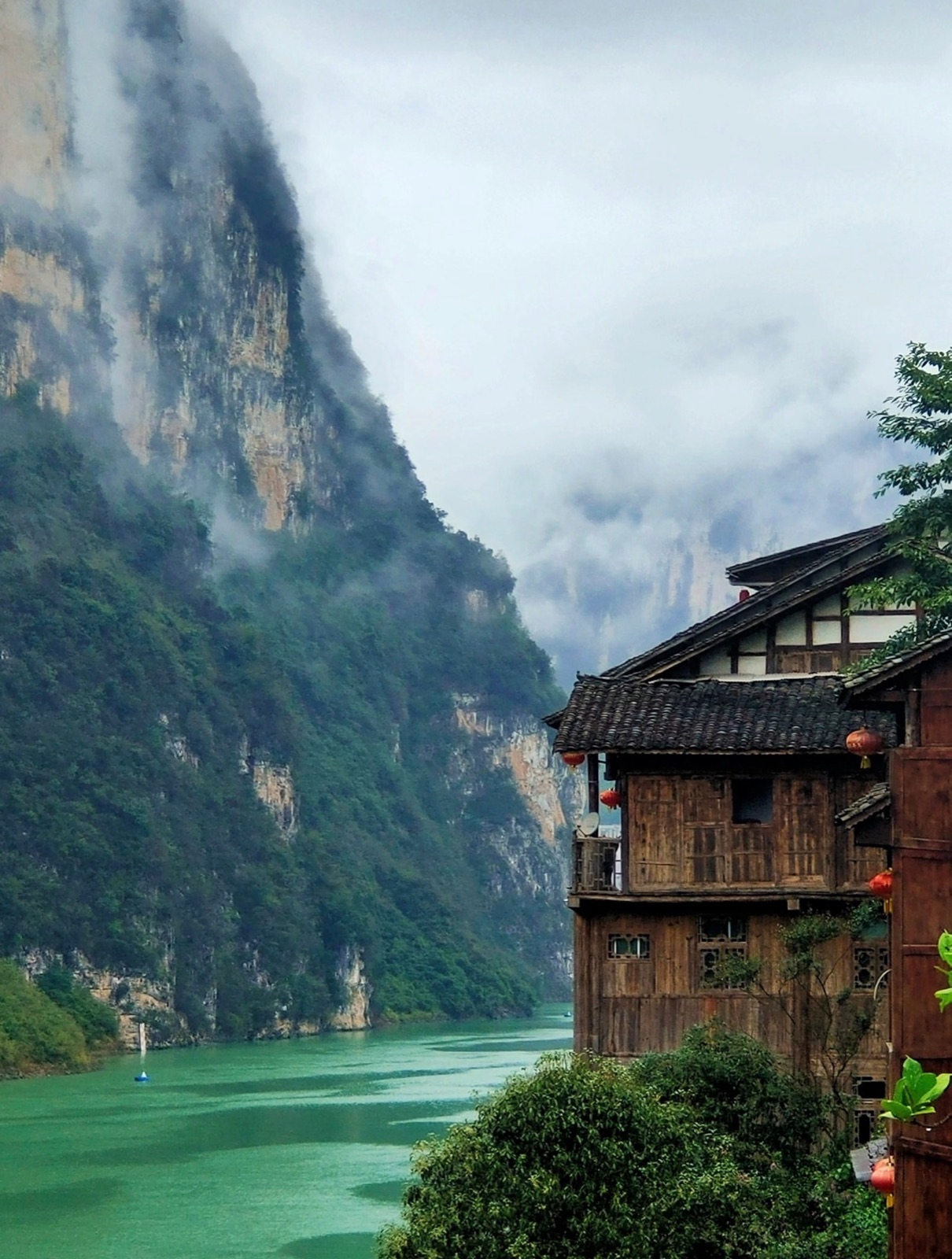 Gongtan's riverside stilted houses framed by the Wu River valley