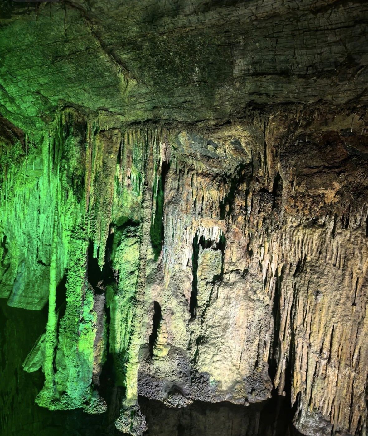 Illuminated limestone formations inside Furong Cave